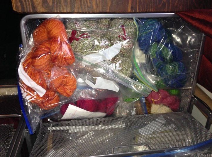 Here's the stash after I scooped the bags up and put them back in the drawer. Sadly, this isn't exactly all of it. There are a few stray hanks hanging out in other areas of the craft room. My theory is that if I don't put them in the drawer they aren't officially part of the stash yet and, therefore, not yet part of the problem. 